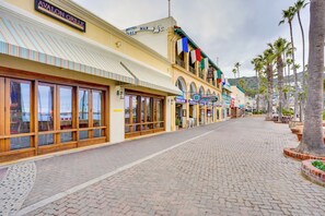A street with storefronts, including a hotel named 'Avalon Grille' and a 'Hotel Mar'. - Steps to Beach & Bites: Catalina Island Retreat! (Avalon)