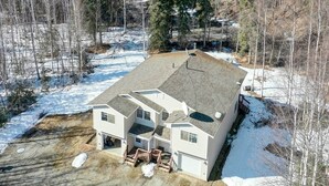 A two-story house with a sloped roof, a covered porch, and a fenced yard. - Peaceful Alaskan Escape: 13 Mi to Fairbanks! (Fairbanks)