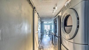 A laundry room with a wooden floor, a washing machine, and a dryer. - North Myrtle Beach Retreat w/ Ocean Views! (North Myrtle Beach)