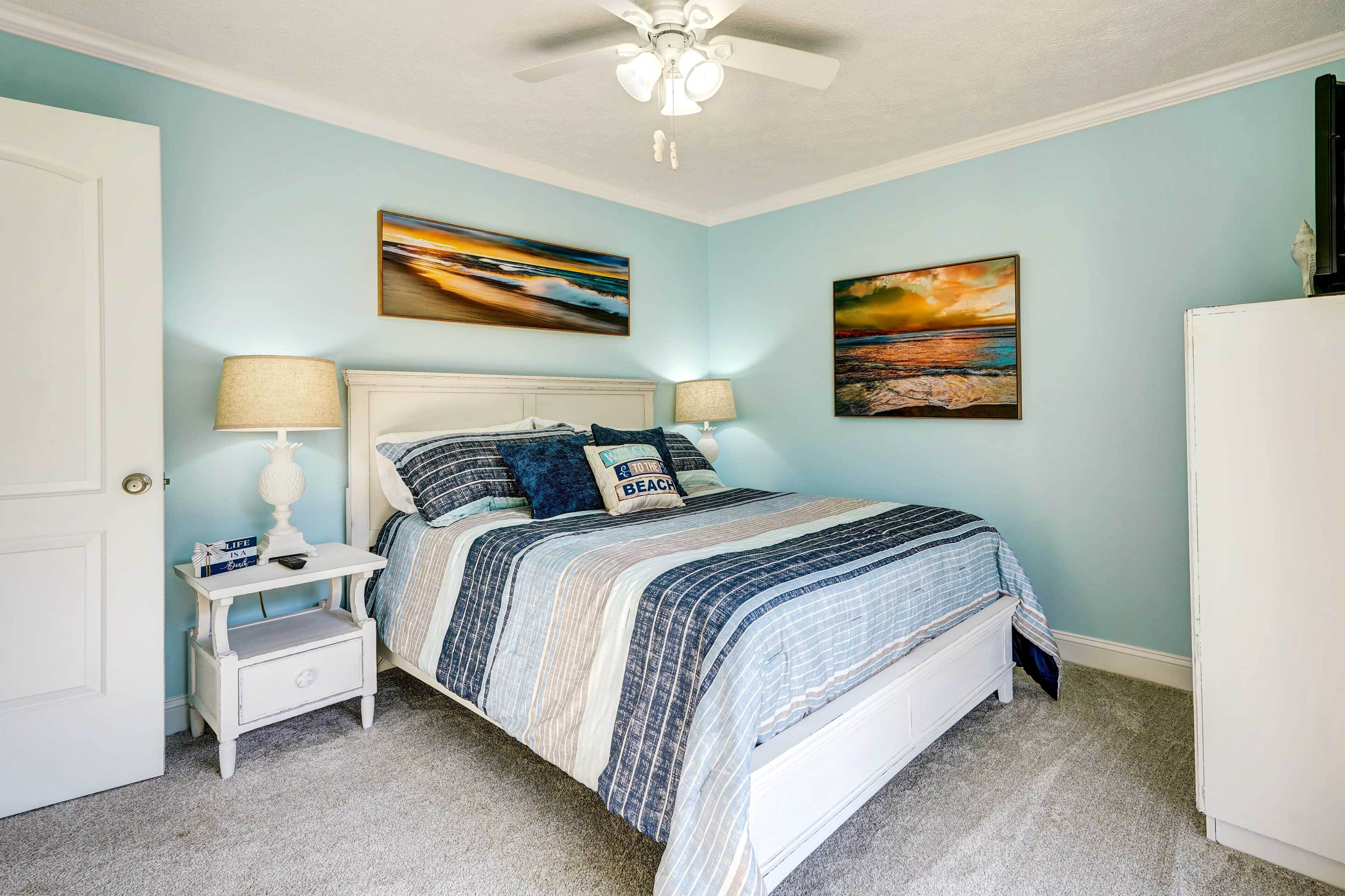A bedroom with a bed, nightstand, and two wall-mounted lamps.