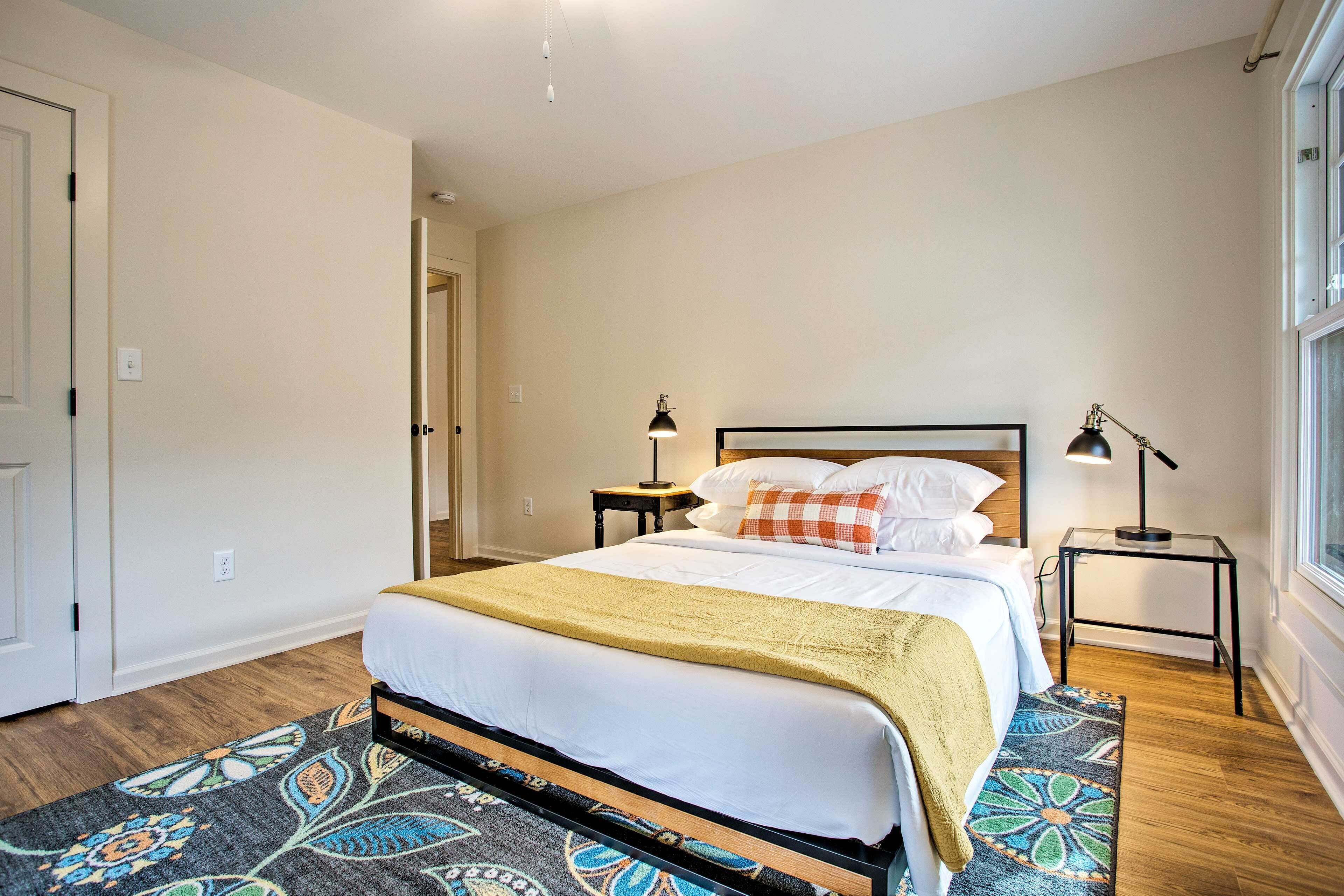 A neatly arranged bedroom with a bed, bedside tables, and a window.