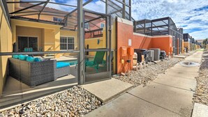 A modern building with glass walls, outdoor seating, and a clear sky. - Poolside Oasis in Paradise Palms: 6 Mi to Disney! (Kissimmee)