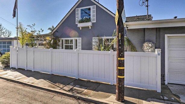 A residential house with a white picket fence, a garage door, and a satellite dish on the roof. - Walk to Ventura Beach: Comfy Home w/ Ocean Views (Ventura)