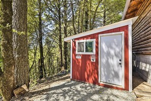 A small red cabin with a white door and window, surrounded by trees. - Mountain Homestead: Swim, Hike, & Camp On-site! (Los Gatos)