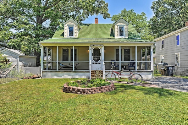 A two-story house with a green roof, a porch, and a sign that reads "Isle Haven Another." - 'isle Have Another' - 1 Block to Colonial Beach! (Colonial Beach)