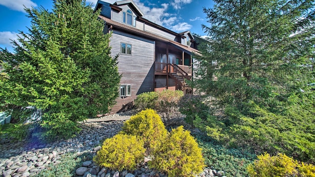 A two-story house with a balcony and a stone pathway leading to the entrance. - Hunter Mountain Ski Retreat - Steps to Lift! (Hunter)