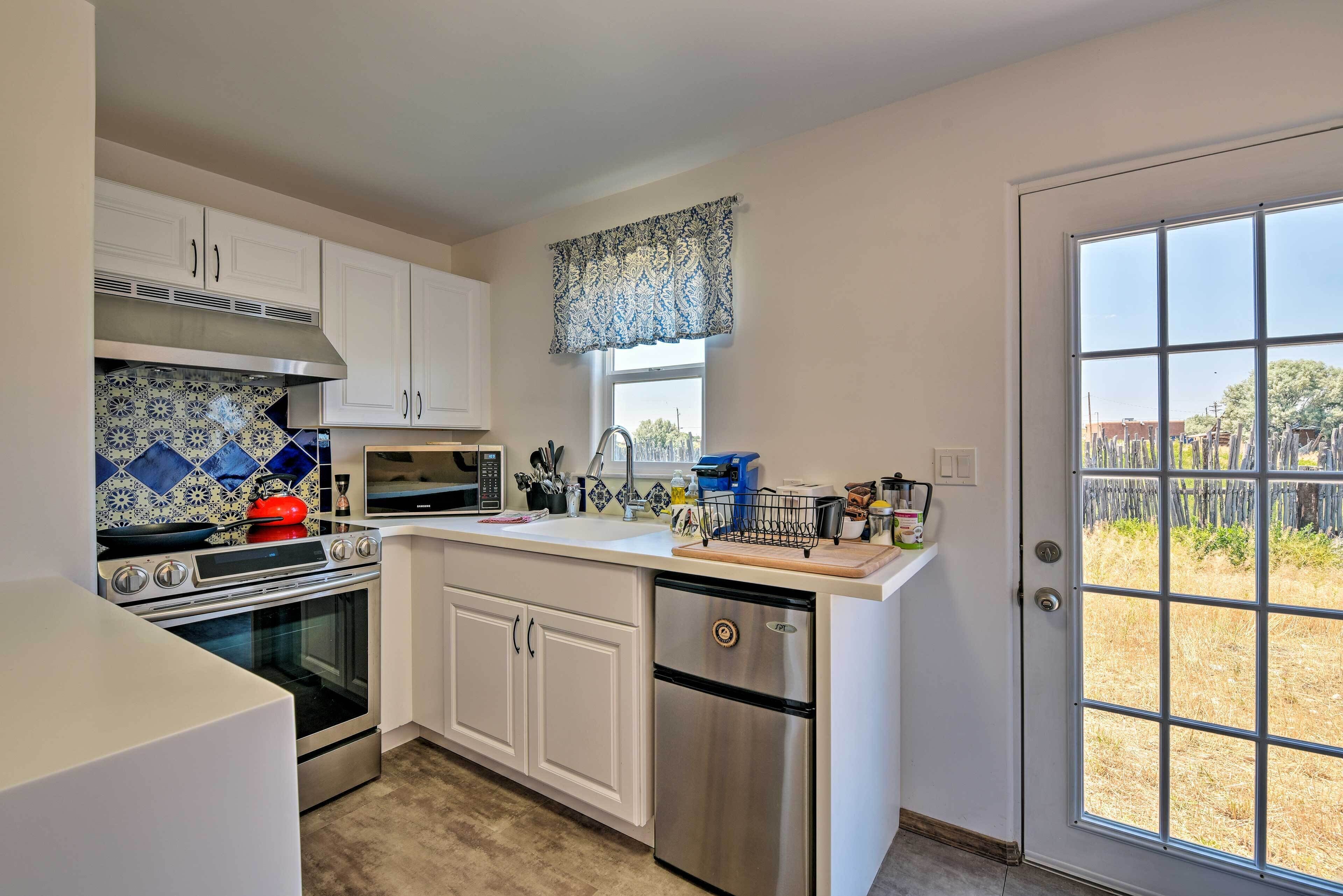 A kitchen with white cabinets, a stainless steel oven, a microwave, and a dishwasher.