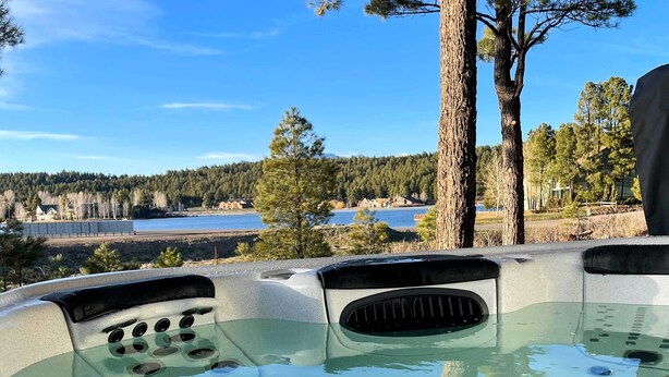 A hot tub with a clear view of a lake and forested area in the background. - Lake Pagosa Home w/ Hot Tub & Mtn/lake Views! (Pagosa Springs)