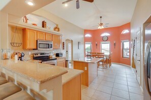 Enjoy cooking in this well-equipped kitchen with a central island, microwave and oven, and ample cabinetry.