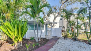 A residential property with a covered porch, a gravel pathway, and various tropical plants. - Indian Rocks Beach Retreat, Walk to Gulf & Beaches (Indian Rocks Beach)