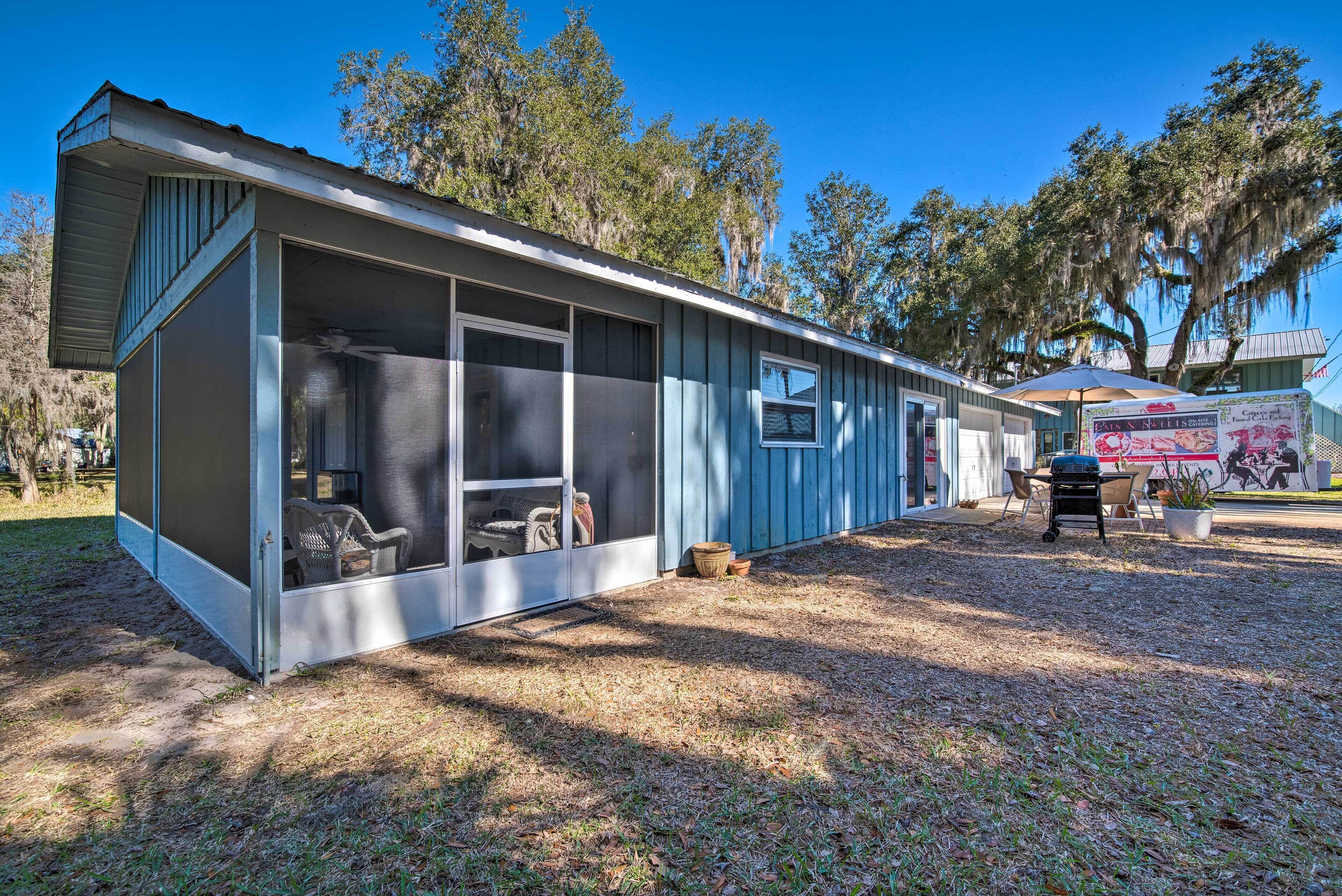 A single-story building with a covered porch and a screened-in area.