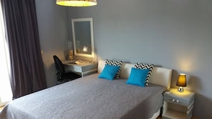 A bedroom with a large bed, a desk, a chair, a lamp, and a mirror. - Apartments Villa Dona - Superior Double Room (Vela Luka)