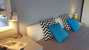 A neatly arranged bedroom with a bed, pillows, a bedside table, and a lamp. - Apartments Villa Dona - Superior Double Room (Vela Luka)