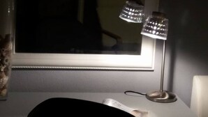 A desk with a lamp, a window, and a reflection of a chair. - Apartments Villa Dona - Superior Double Room (Vela Luka)