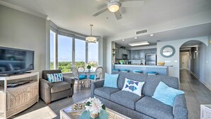 A spacious living room with a grey sofa, a television, and a dining area with chairs and a table. - ~ 2 Mi to Disney & Universal: Orlando Resort Condo (Orlando)
