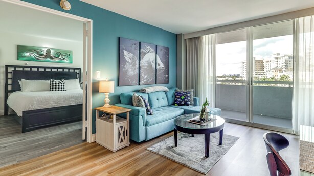 A modern bedroom with a bed, a sofa, and a balcony with a city view. - Modern Ft Lauderdale Condo ~ 7 Mi to Airport! (Fort Lauderdale)