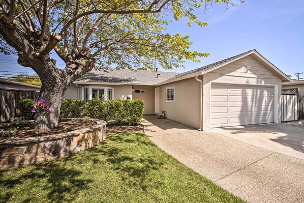 A residential house with a garage, a tree, and a well-maintained lawn. - Family Home in Walkable Area Near Silicon Valley! (San Jose)
