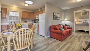A compact living space with a kitchen, dining area, and a small bedroom. - Centrally Located South Hill Apartment w/ Smart TV (Spokane)