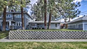 A residential area with two-story houses, a stone retaining wall, and a sidewalk. - Centrally Located South Hill Apartment w/ Smart TV (Spokane)