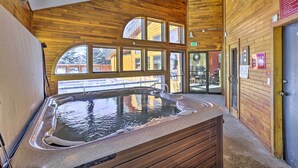 A hot tub in a room with wooden walls and large windows. - Mtn/lake Views & 3 Mi to Skiing: Dillon Condo (Dillon)
