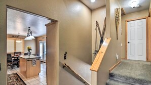 A home interior with a kitchen area, a dining table, and a staircase. - Family-friendly Home w/ Hot Tub: 1 Mi to Dtwn (Estes Park)