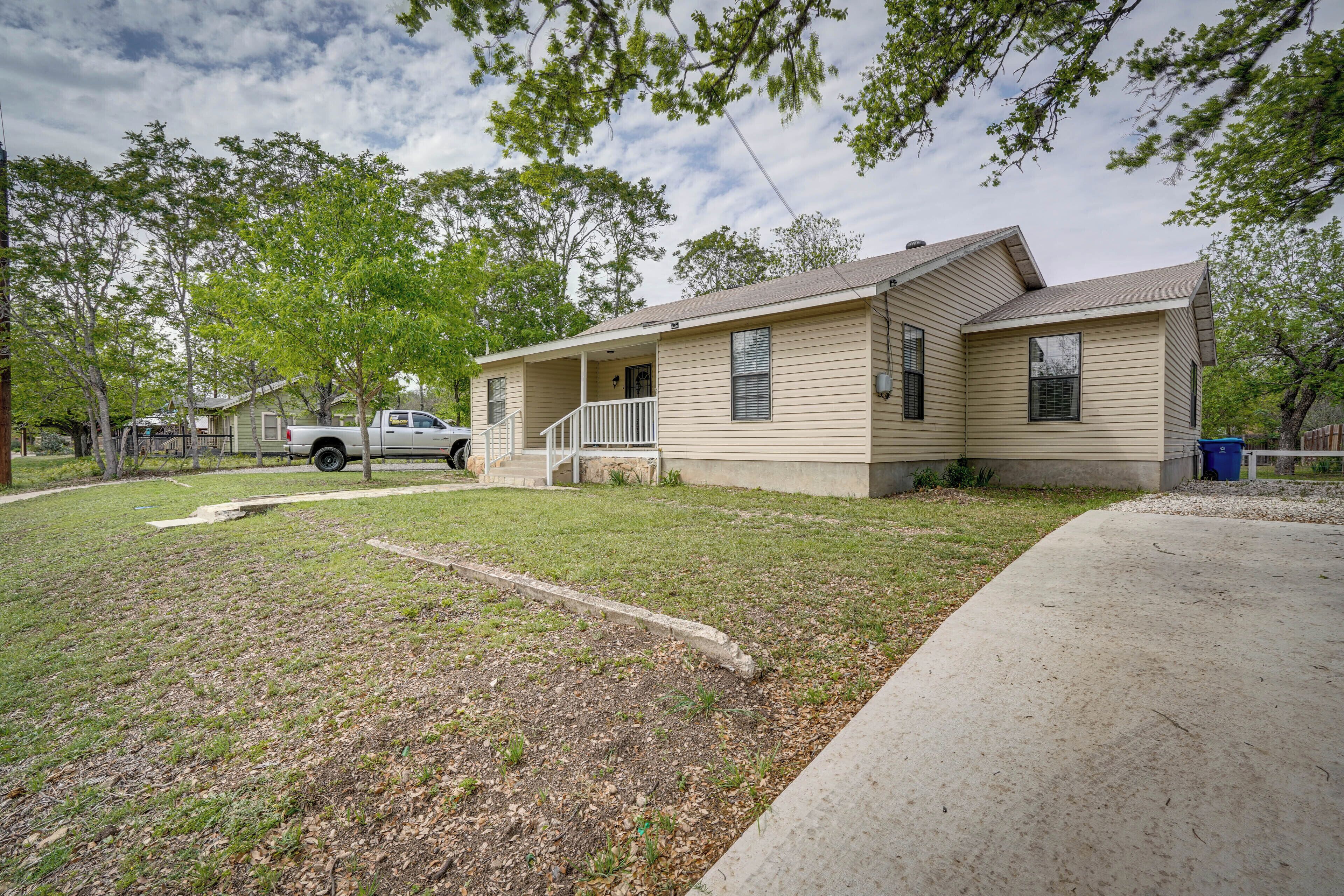 A single-story house with a front porch, a driveway, and a lawn.