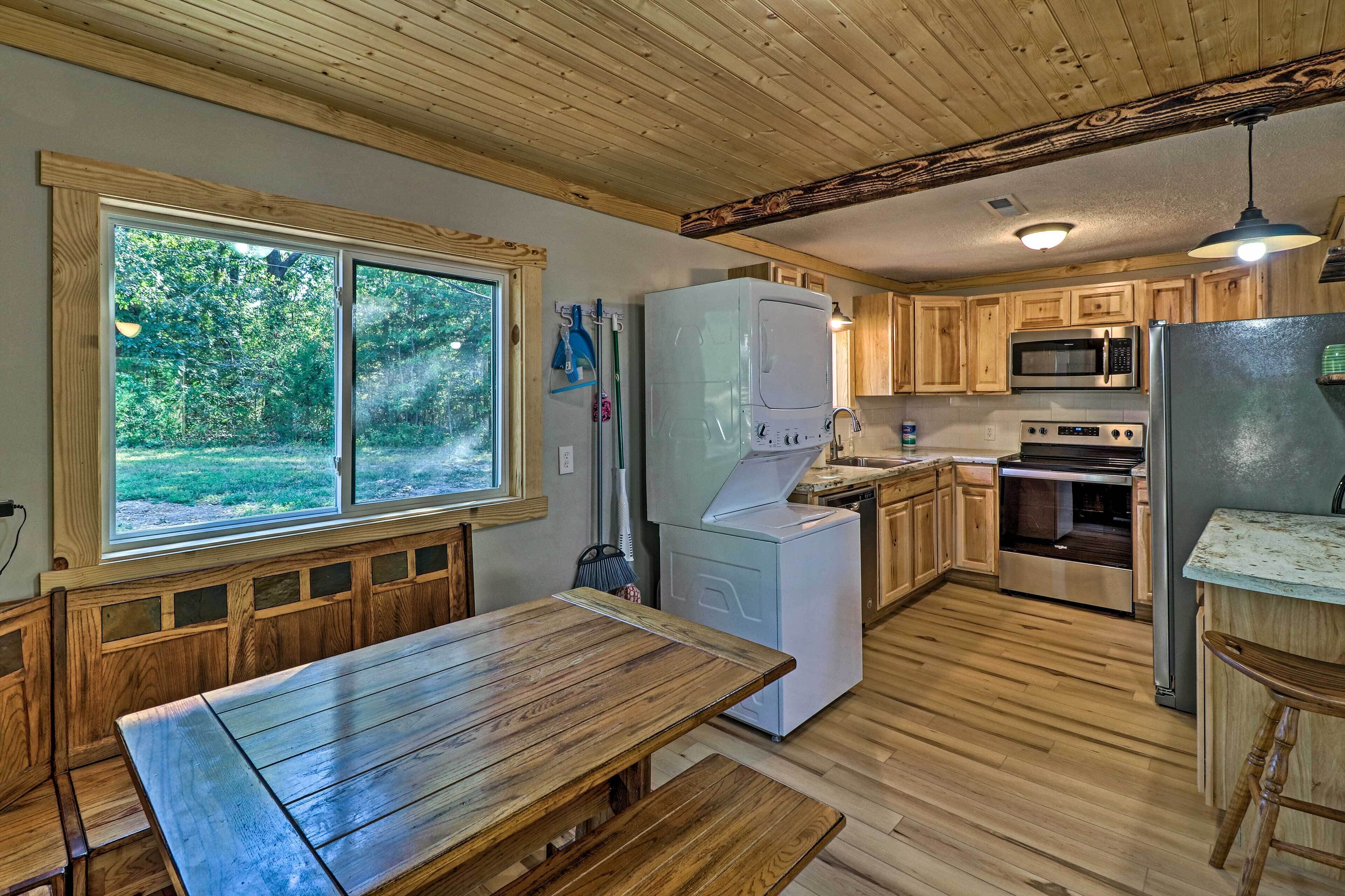 A kitchen with wooden cabinets, a white refrigerator, a microwave, and a stove.