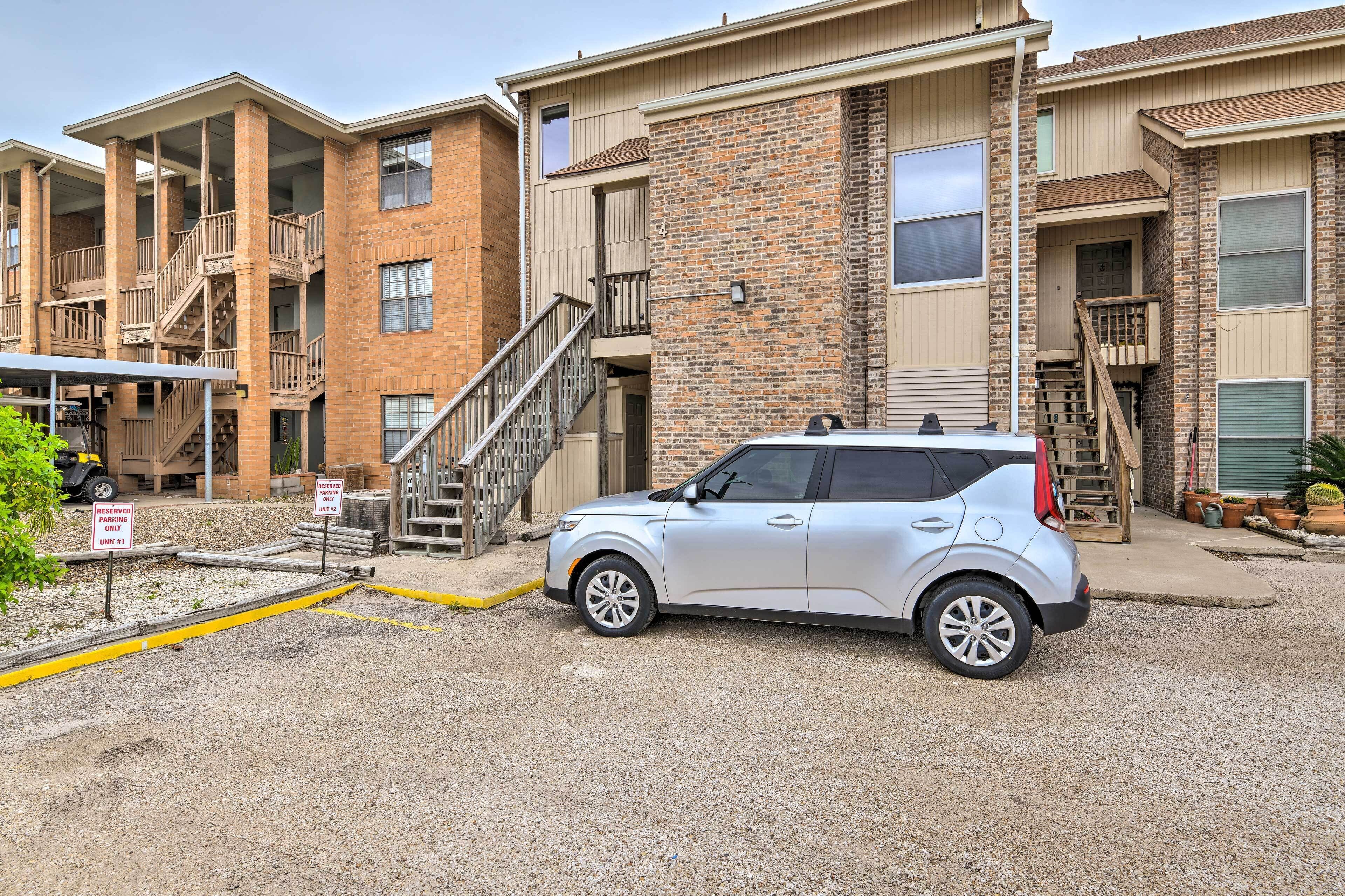 A multi-story building with a parking area.