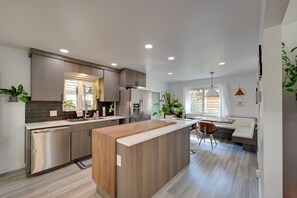 A modern kitchen with a central island, built-in appliances, and ample natural light. - < 7 Mi to Dtwn: Denver Home w/ Large Yard! (Denver)