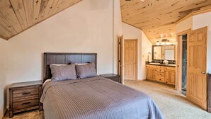 A bedroom with a wooden ceiling, a bed with a grey quilt, a nightstand, and a wooden wardrobe. - 2 Mi to Dtwn: Leadville Haven w/ 2 Furnished Decks (Leadville)