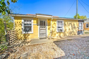 A yellow single-story house with a front door, two windows, and a small porch area. - Pet-friendly Hot Springs Abode < 1 Mi to Dtwn (Hot Springs)