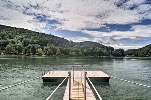 A wooden dock extending into a calm lake with a forested hillside in the background. - Watauga Lake Butler Retreat w/ Private Dock! (Butler)