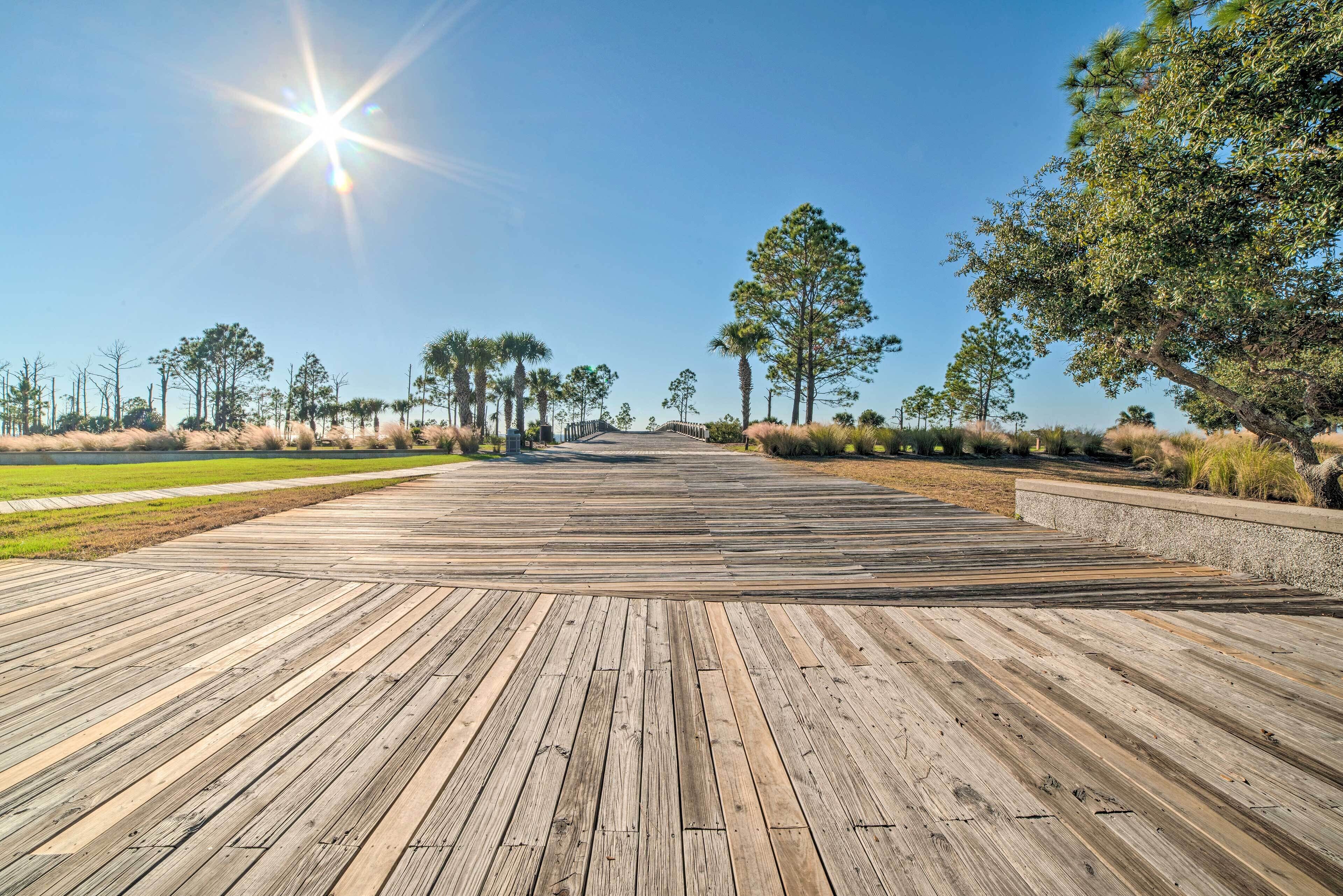 A wooden deck with a clear view of the sky and surrounding trees.