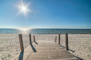 A wooden boardwalk leading to a sandy beach with a clear blue sky and the sun shining. - Walk to Shore: 'oyster House' Port St Joe Getaway (Port St. Joe)