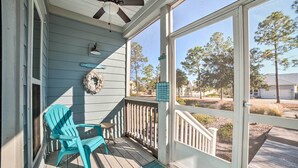 A covered porch with a ceiling fan, a turquoise Adirondack chair, a welcome sign, and a sign indicating a beach house. - Walk to Shore: 'oyster House' Port St Joe Getaway (Port St. Joe)