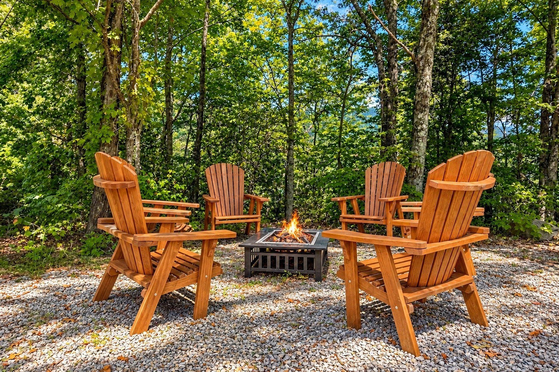 Four wooden Adirondack chairs arranged around a square fire pit in a forest setting.
