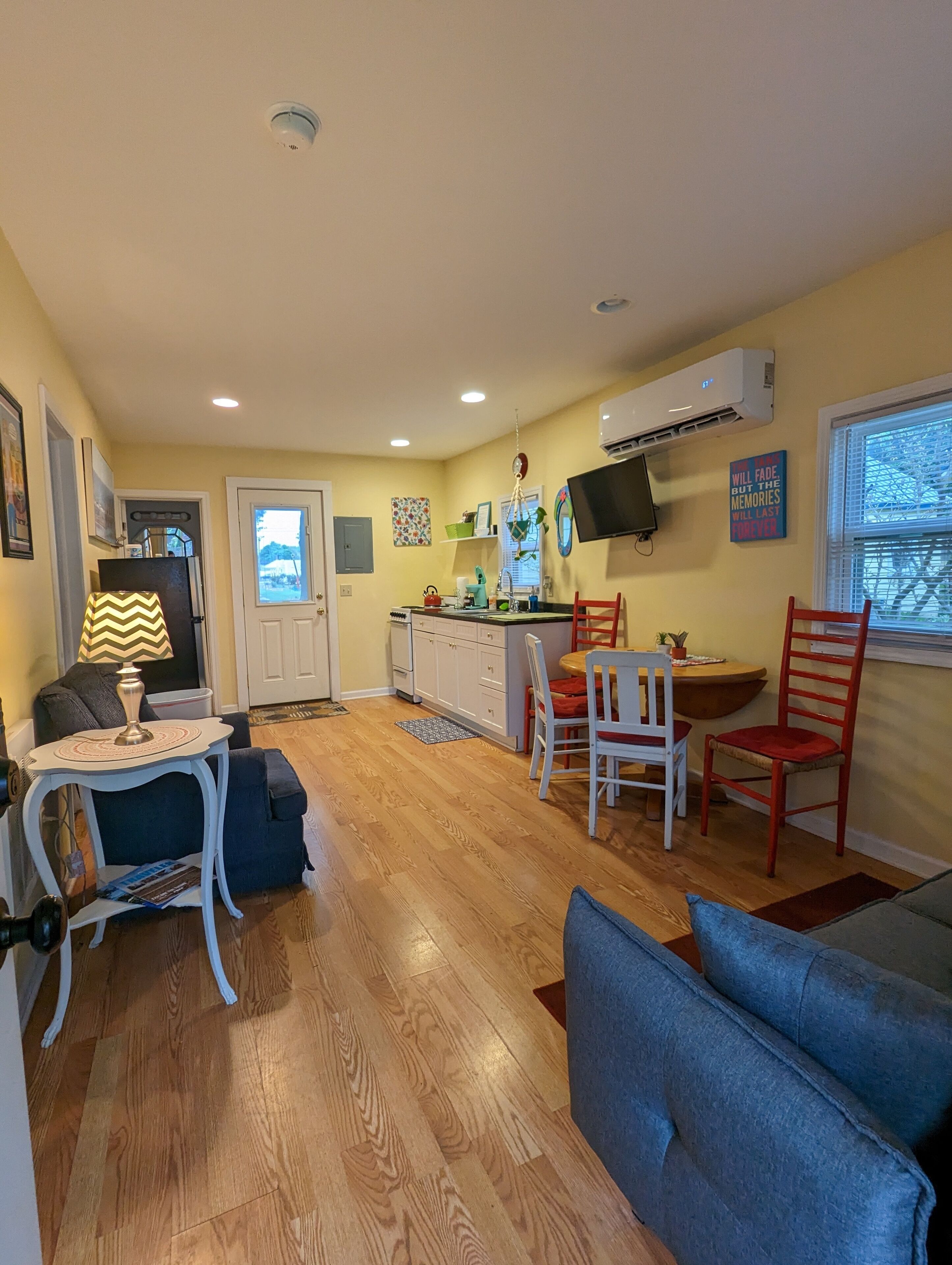 A compact living space with a kitchenette, dining area, and seating area.