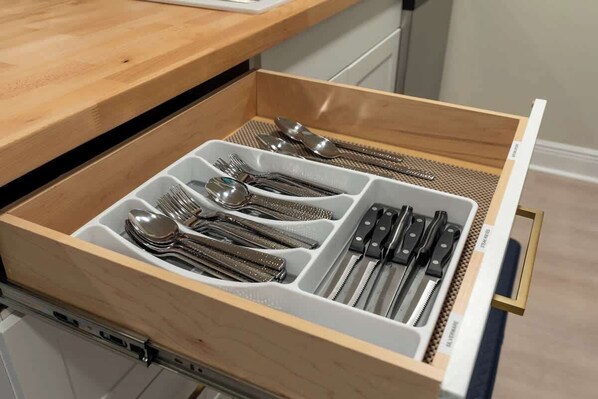A drawer with compartments containing various utensils. - Sleep 4 | King Bed | Golf Course (Daphne)