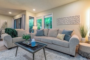 A living room with a sofa, coffee table, and decorative items.