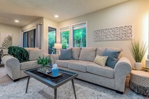 A living room with a sofa, coffee table, and decorative items.