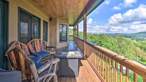 A wooden deck with a glass-top table and chairs, overlooking a scenic landscape. - 'high Gravity' Banner Elk Custom Chalet w/ Views! (Banner Elk)