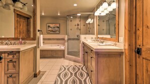 A bathroom with a shower, bathtub, and two sinks. - Expansive Bigfork Resort Retreat on Flathead Lake! (Bigfork)