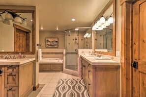 A bathroom with a shower, bathtub, and two sinks. - Expansive Bigfork Resort Retreat on Flathead Lake! (Bigfork)
