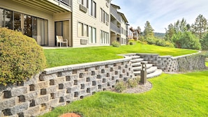 A multi-story residential building with balconies, large windows, and a well-maintained lawn. - Expansive Bigfork Resort Retreat on Flathead Lake! (Bigfork)