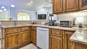 A kitchen with wooden cabinets, a dishwasher, a toaster, and a blender. - Ocean Springs Home w/ Fire Pit & Game Room! (Biloxi)