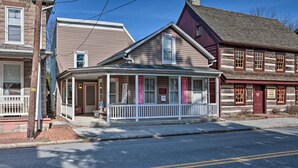 A two-story building with a porch and a small shop on the ground floor. - Central Hummelstown Apt: 4 Miles to Hershey Park! (Hummelstown)