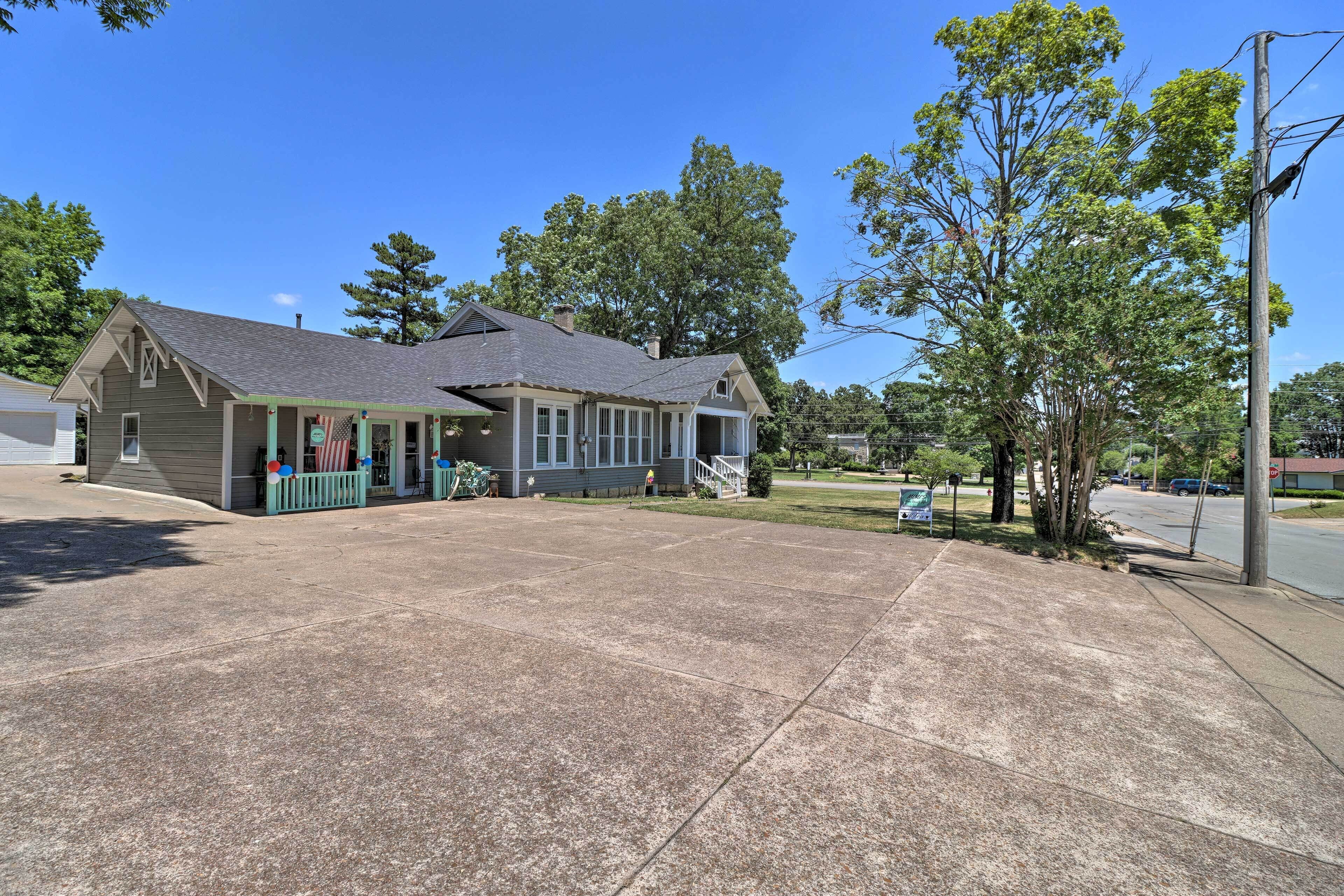 A two-story building with a porch and a covered front entrance.