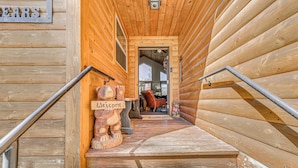 A wooden staircase leading to a room with a 'Welcome' sign and a teddy bear decoration. - Ruidoso Cabin w/ Hot Tub, 2 Mi to Grindstone Lake! (Ruidoso)