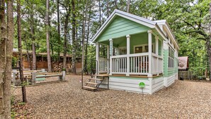 A lodge with a porch, wooden deck, and a sign that says "Welcome". - Cozy Broken Bow Getaway w/ Fire Pit, 5 Mi to Lake! (Broken Bow)