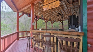A wooden bar area with a sign reading "Saddle Up Tennessee BAR Grill".